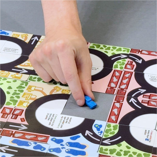Roundabouts – Tile-Laying Card Game, gameplay blocking a spot with a car token